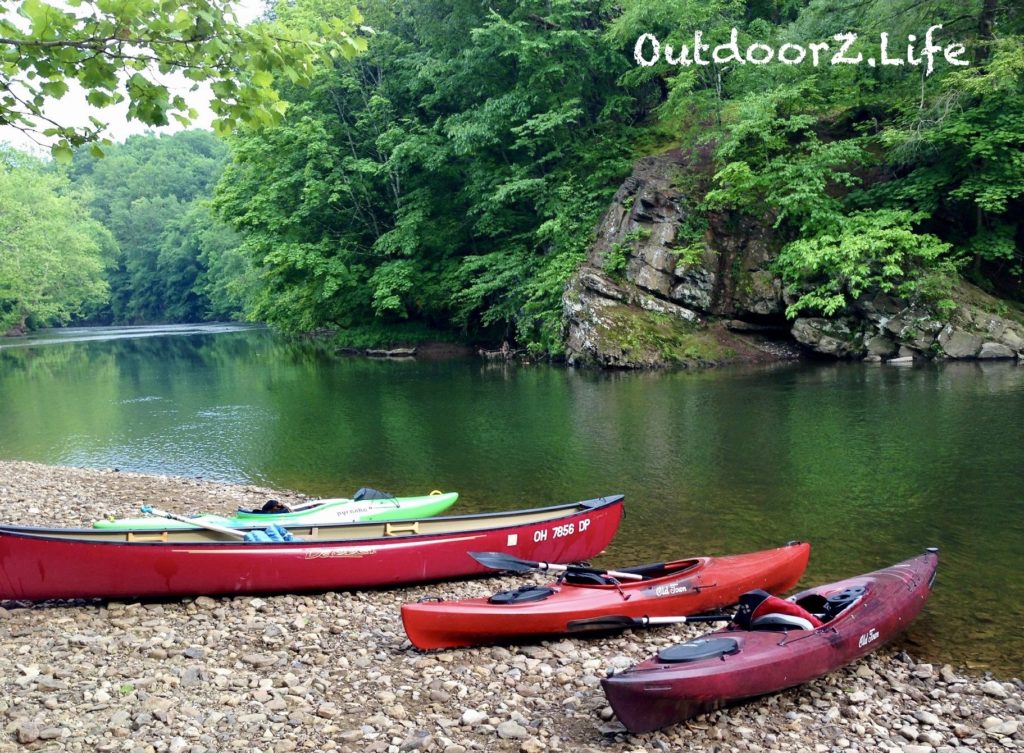 Canoe and kayaks on a river bank