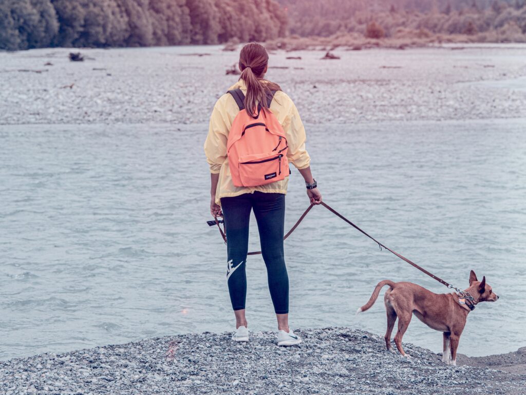 Woman hiking with her dog on a leash