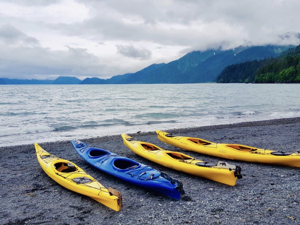 Kayaks next to a lake.