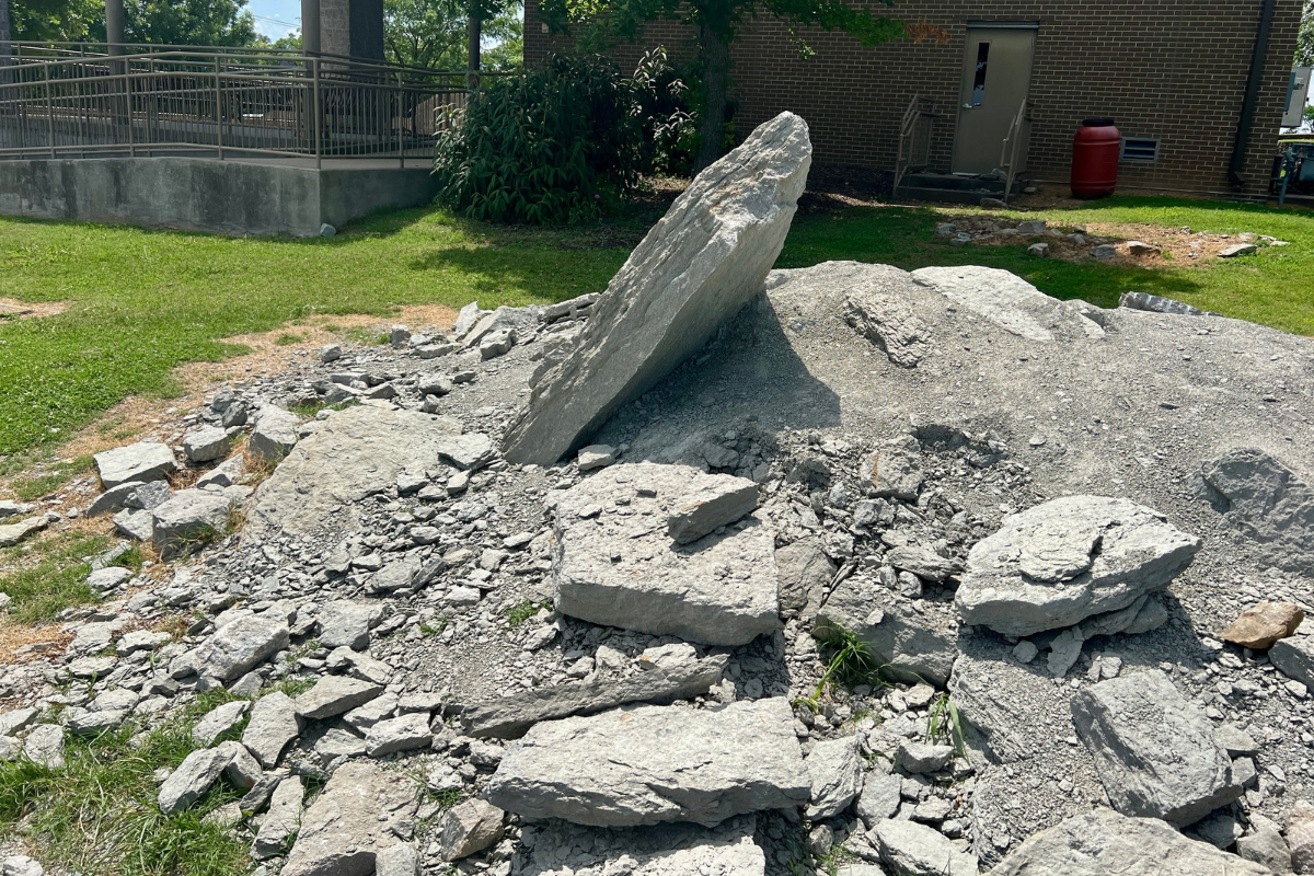 Pile of gray quarry rocks and large slabs outside the Fort Negley visitor center